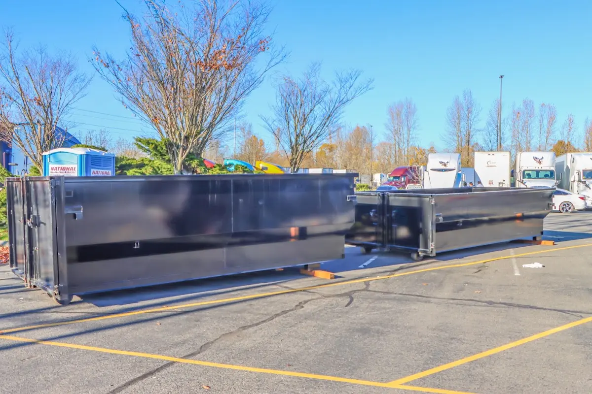 Professional dumpster rental service with roll-off container on residential driveway in Rockville Centre
